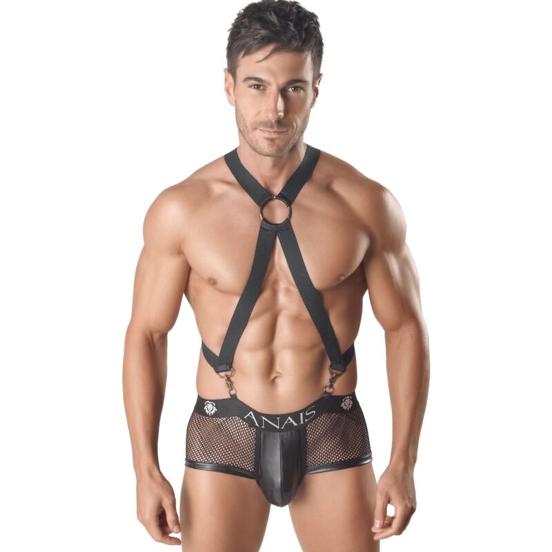 A man wearing a black male body harness with adjustable straps and an attached underwear, branded with 'ANAIS'. Anais Men Axel Harness adjustable men's body harness with metallic details